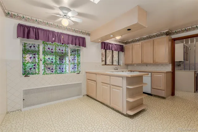 a kitchen with kitchen island granite countertop a stove a sink and a refrigerator