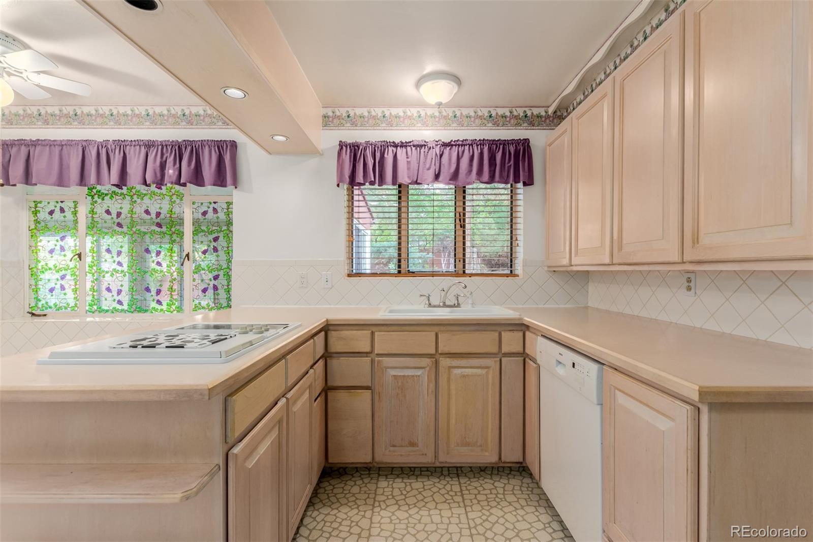 3880 Independence Court Wheat Ridge, CO 80033 - Photo 22 of 47 a kitchen that has a sink and a stove in it