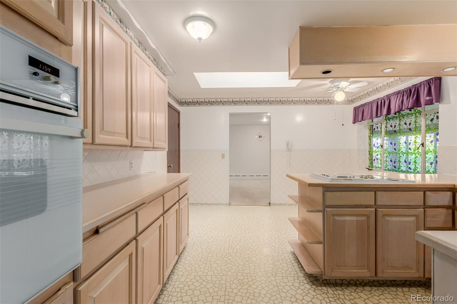 3880 Independence Court Wheat Ridge, CO 80033 - Photo 23 of 47 a kitchen with stainless steel appliances granite countertop a sink and cabinets
