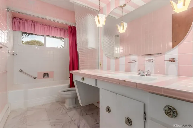 a bathroom with a granite countertop sink a toilet and bathtub