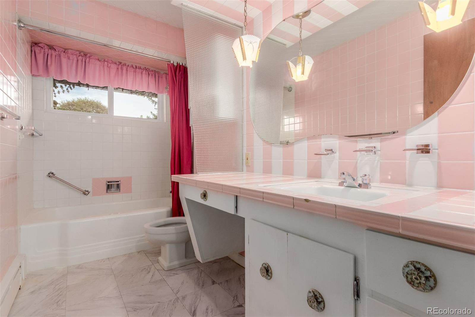 3880 Independence Court Wheat Ridge, CO 80033 - Photo 28 of 47 a bathroom with a granite countertop sink a toilet and bathtub