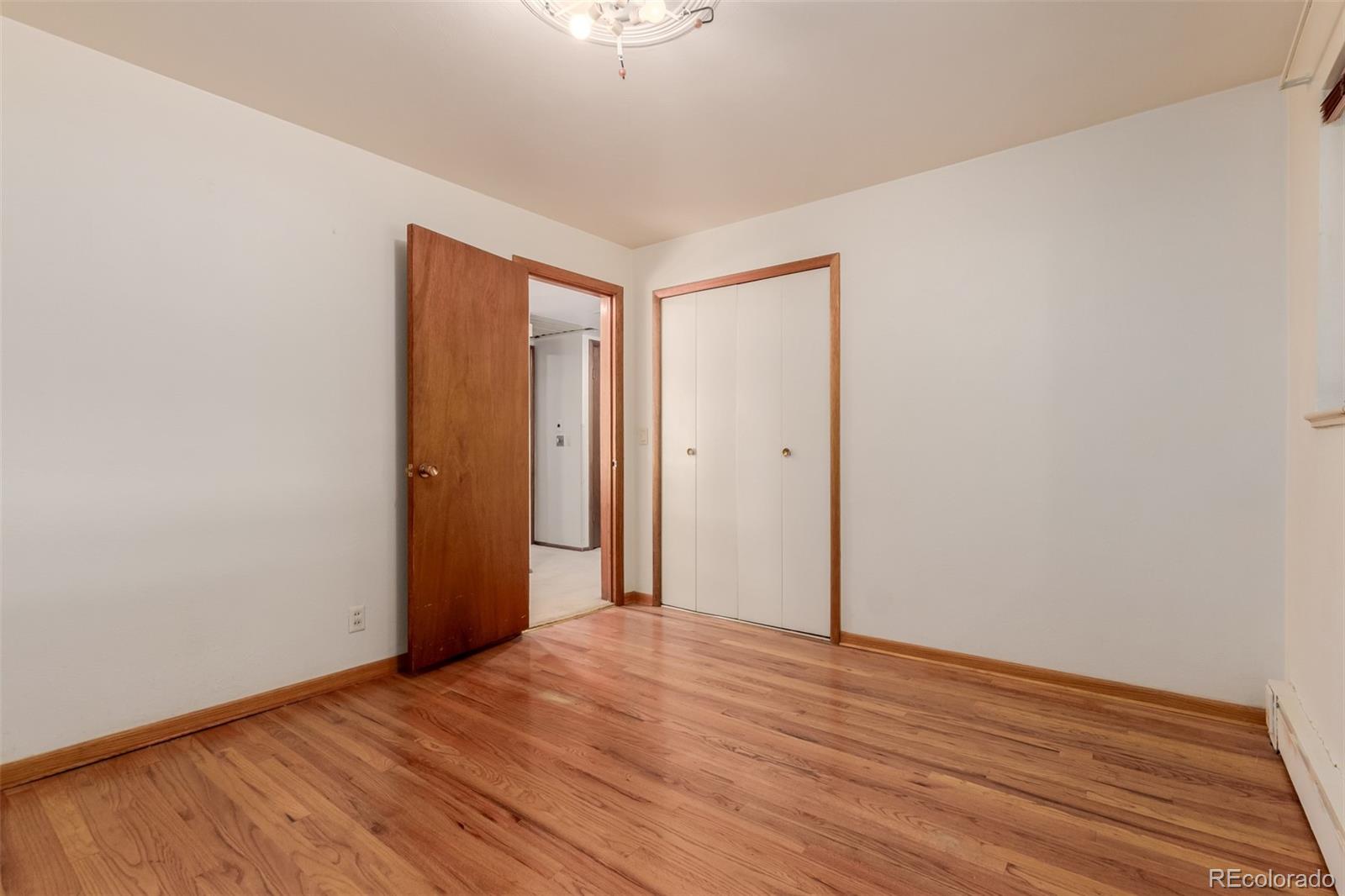 3880 Independence Court Wheat Ridge, CO 80033 - Photo 30 of 47 a view of empty room with wooden floor
