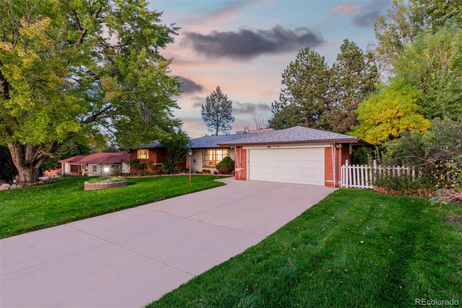 3880 Independence Court Wheat Ridge, CO 80033 - Photo 5 of 47 a view of a house with a yard and a large tree