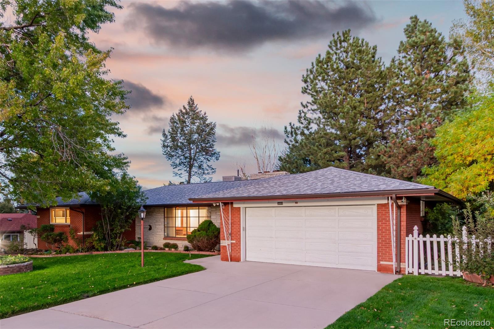 3880 Independence Court Wheat Ridge, CO 80033 - Photo 6 of 47 a front view of a house with a yard and garage
