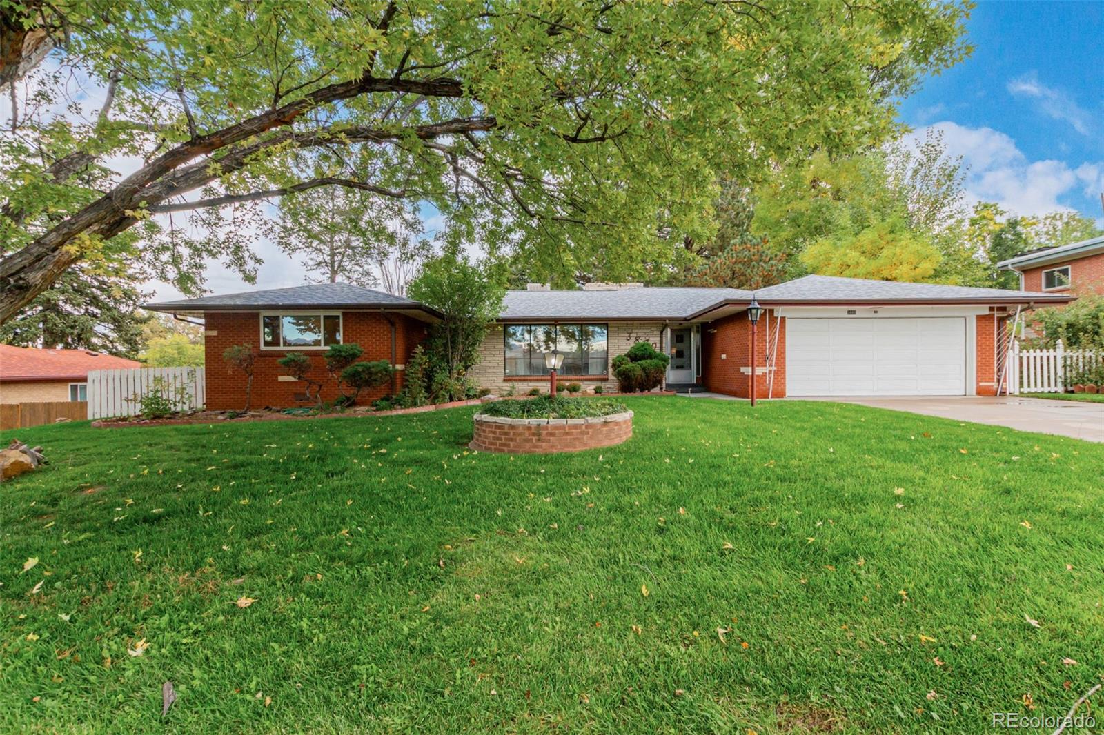 3880 Independence Court Wheat Ridge, CO 80033 - Photo 8 of 47 a front view of a house with a yard