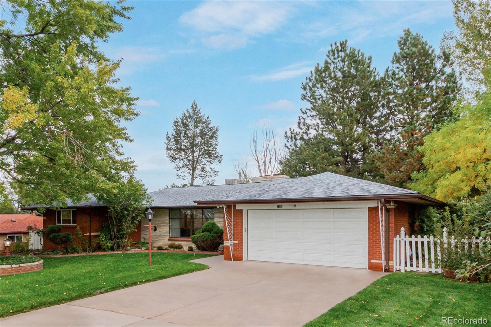 3880 Independence Court Wheat Ridge, CO 80033 - Photo 10 of 47 a front view of a house with a yard