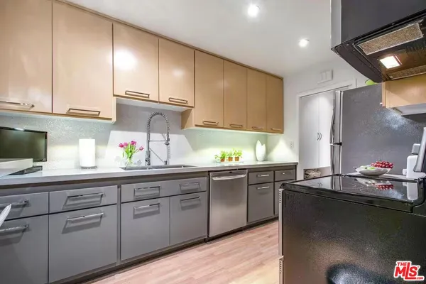 a kitchen with granite countertop cabinets and white appliances