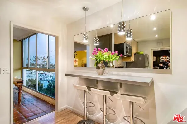 a view of a dining room and kitchen with a table chairs