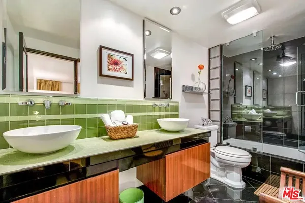 a bathroom with a sink mirror and toilet