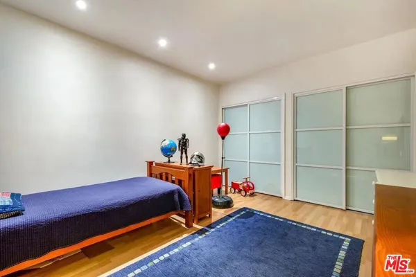 a bedroom with furniture and a wooden floor
