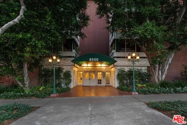 a view of a building and a yard in front of a house