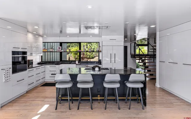 a large kitchen with a table and chairs