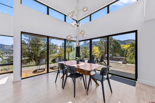 a dining room with furniture window and wooden floor