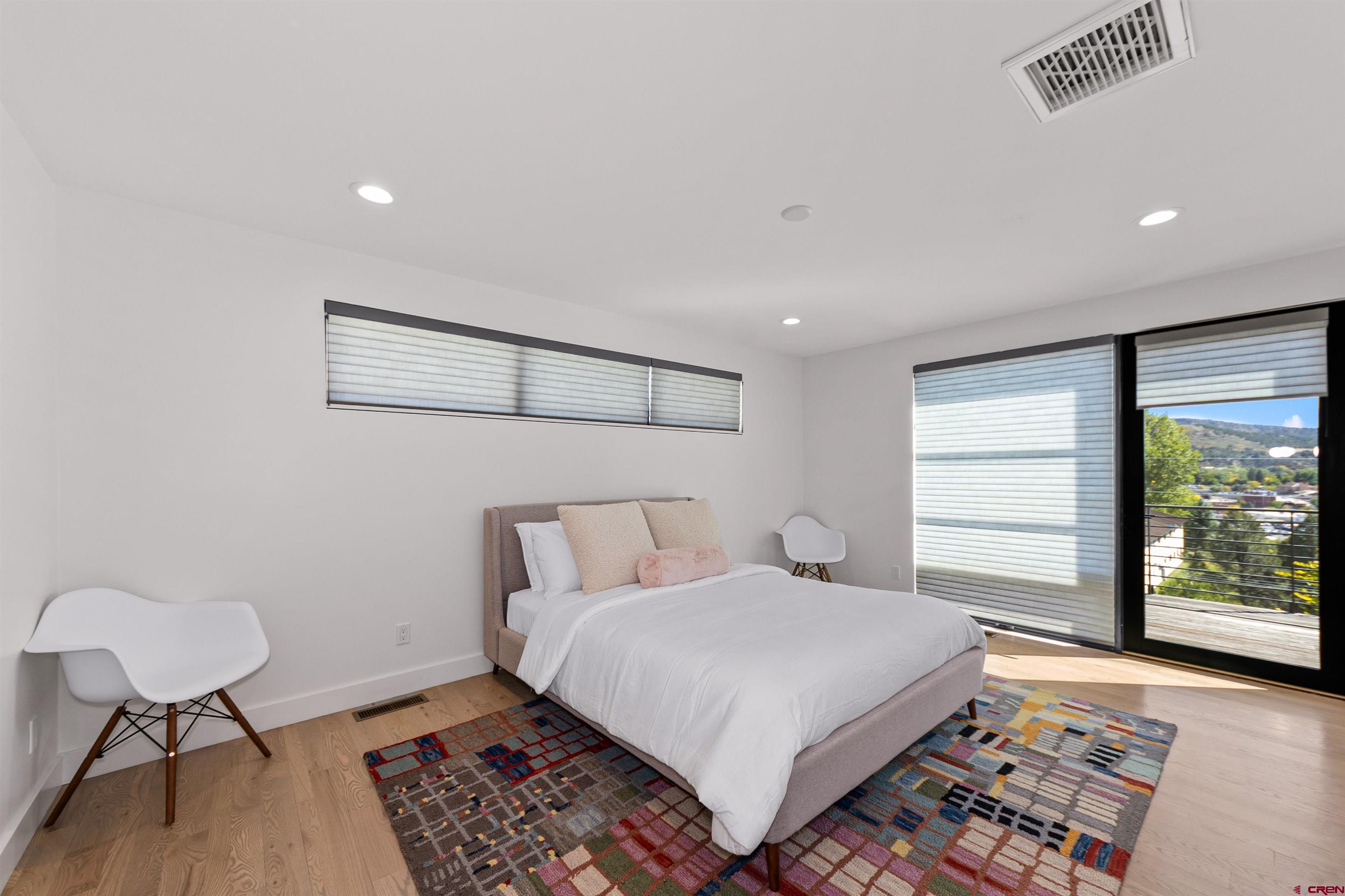 12 Falcon Way Durango, CO 81301 - Photo 18 of 38 a bedroom with a bed a chair and next to a window