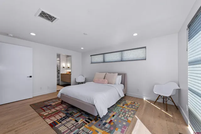 a bedroom with a bed and a table in it