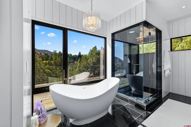 a living room with furniture and a floor to ceiling window