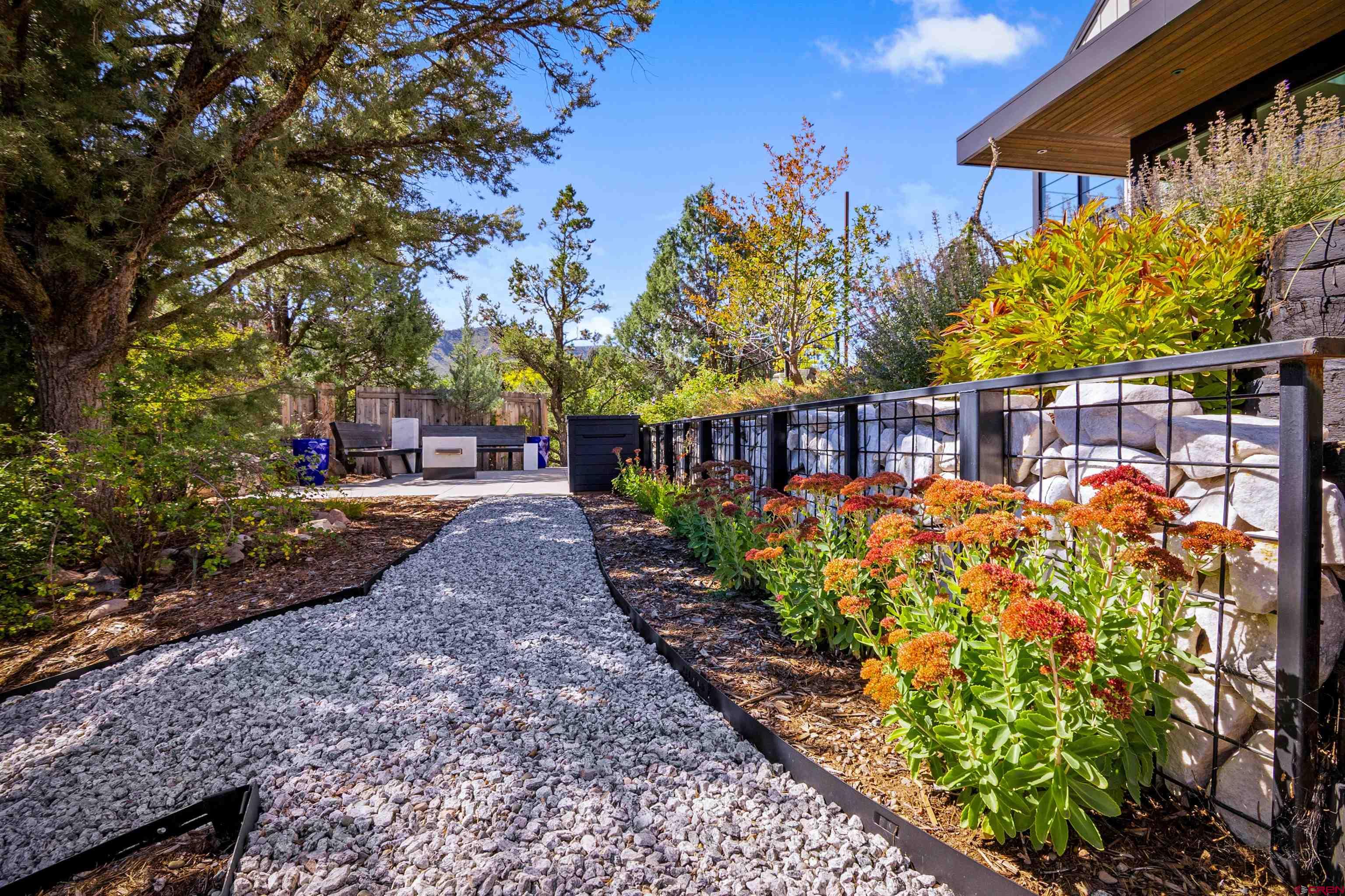 12 Falcon Way Durango, CO 81301 - Photo 34 of 38 a view of a pathway with a flower garden