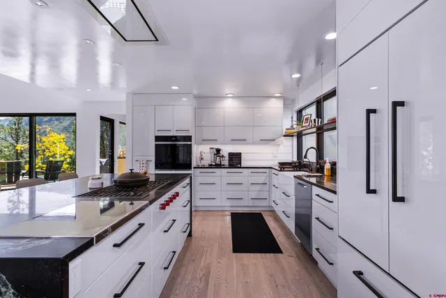 a kitchen with stainless steel appliances a stove sink and cabinets