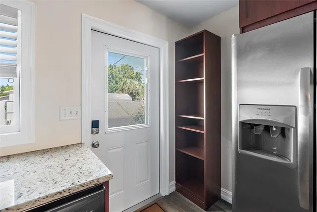 a kitchen with a refrigerator and window