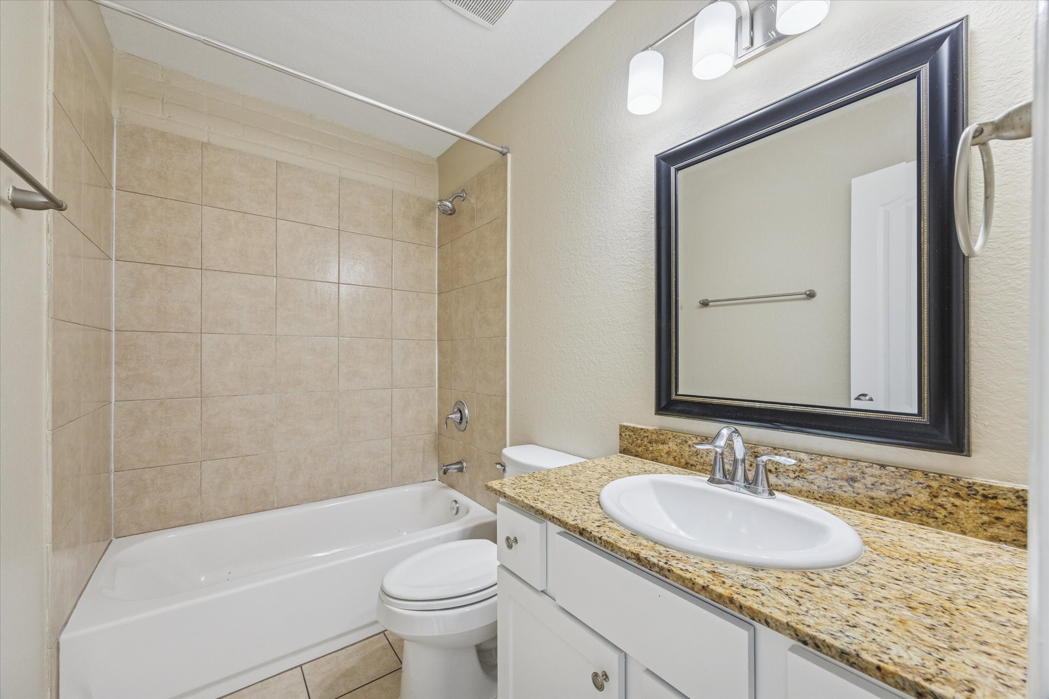 300 Pecore Street, Unit 19 Houston, TX 77009 - Photo 9 of 10 a bathroom with a granite countertop sink toilet mirror and bathtub