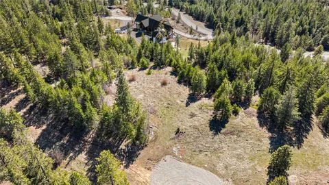 a view of a lush green hillside and houses