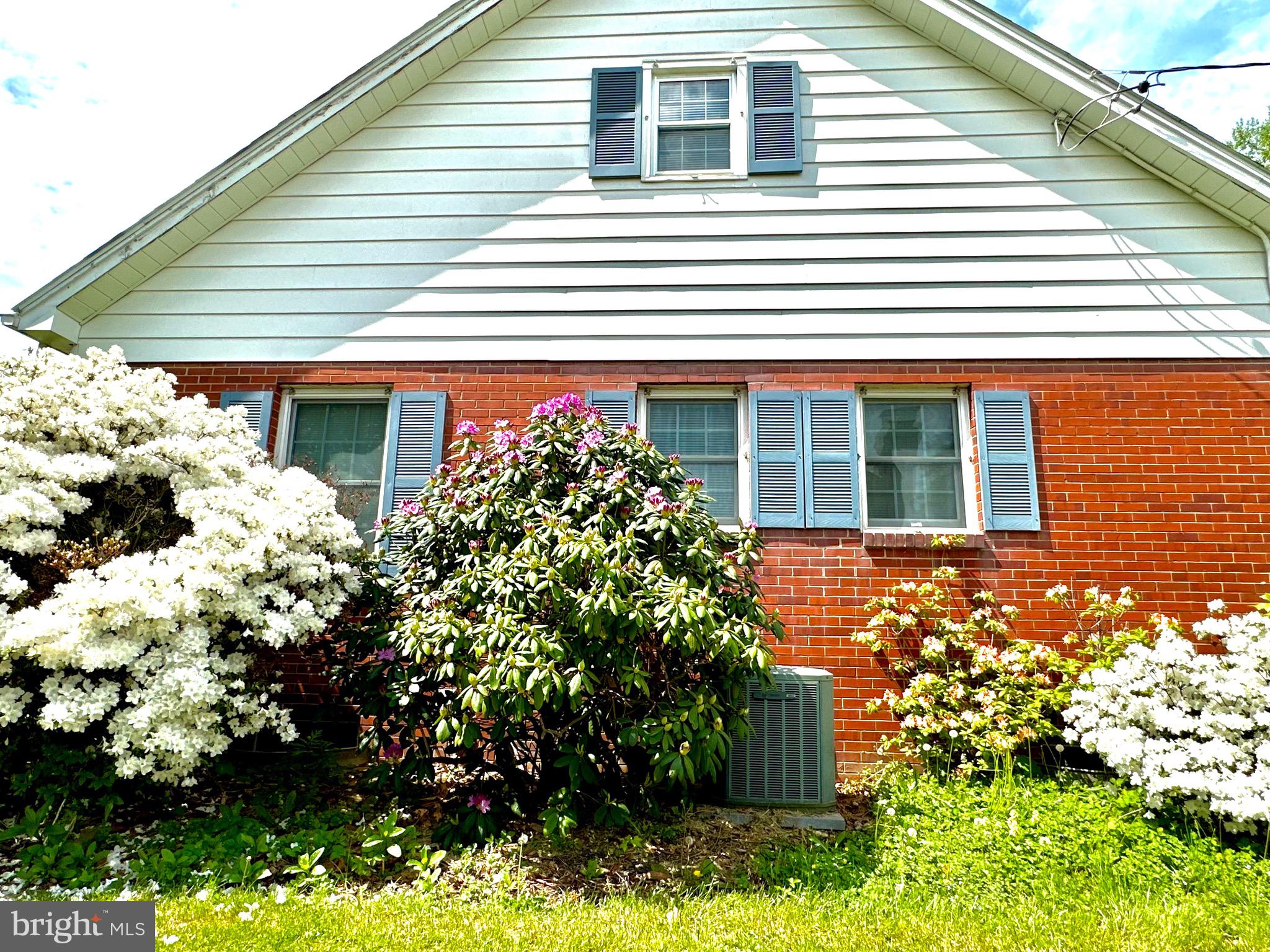 116 Main Street Townsend, DE 19734 - Photo 20 of 68 a front view of a house with a yard and potted plants
