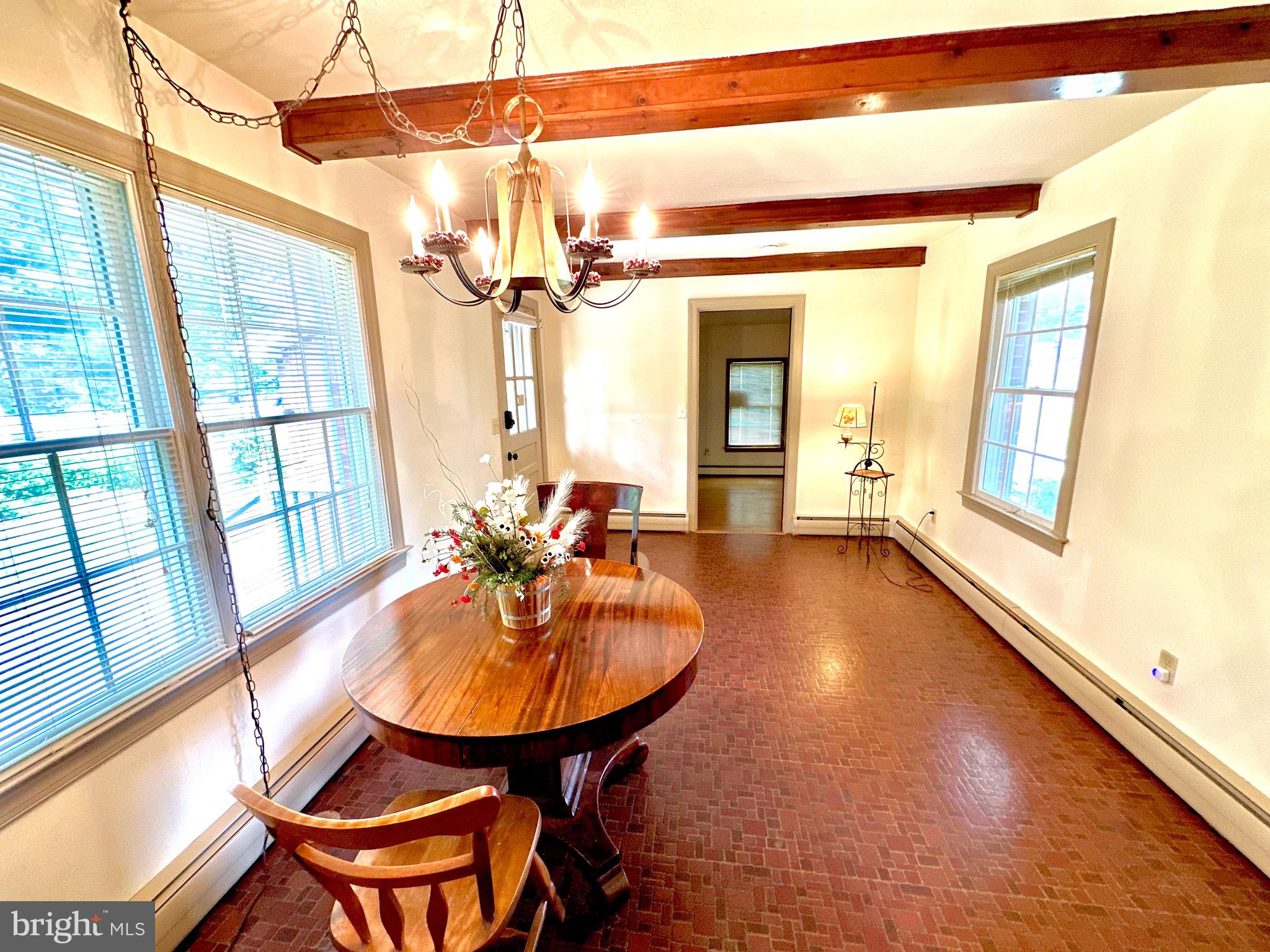 116 Main Street Townsend, DE 19734 - Photo 25 of 68 a view of a dining room with furniture a chandelier and wooden floor