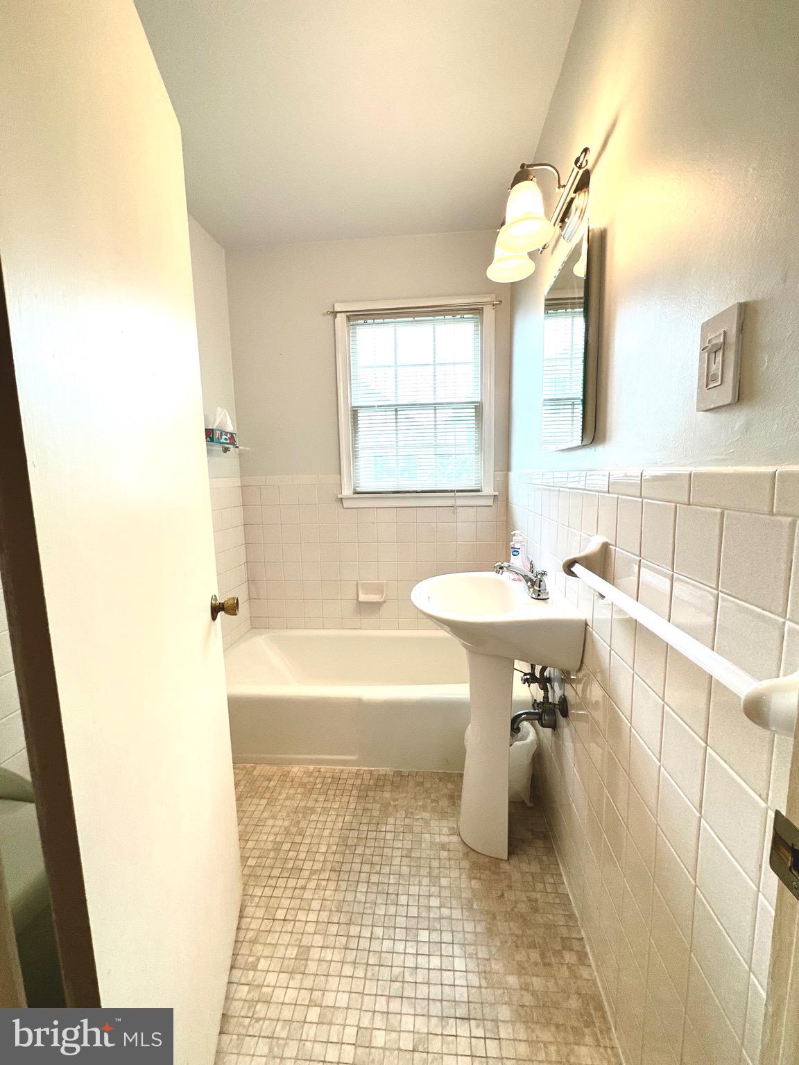 116 Main Street Townsend, DE 19734 - Photo 45 of 68 a bathroom with a sink a mirror and a bathtub