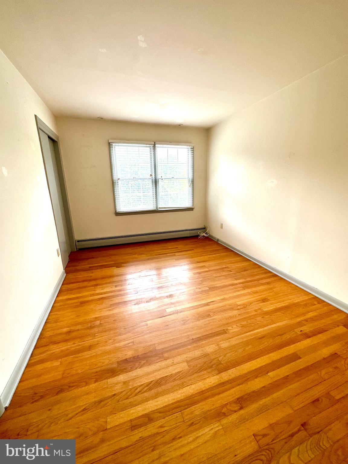 116 Main Street Townsend, DE 19734 - Photo 54 of 68 a view of an empty room with wooden floor and a window