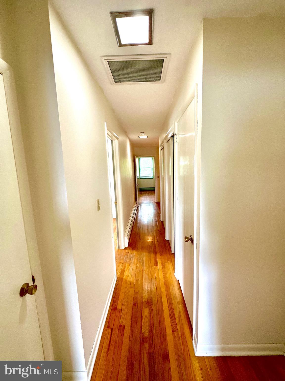 116 Main Street Townsend, DE 19734 - Photo 57 of 68 a view of a hallway with wooden floor and a bathroom