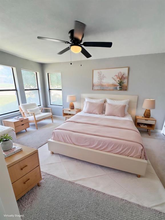 1736 Ransom Terrace Fort Worth, TX 76112 - Photo 14 of 27 Main Bedroom with light gray wall paint, a dark-toned ceiling fan with integrated lighting, and multiple large windows