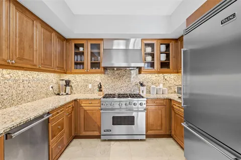 a kitchen with a stove top oven sink and cabinets