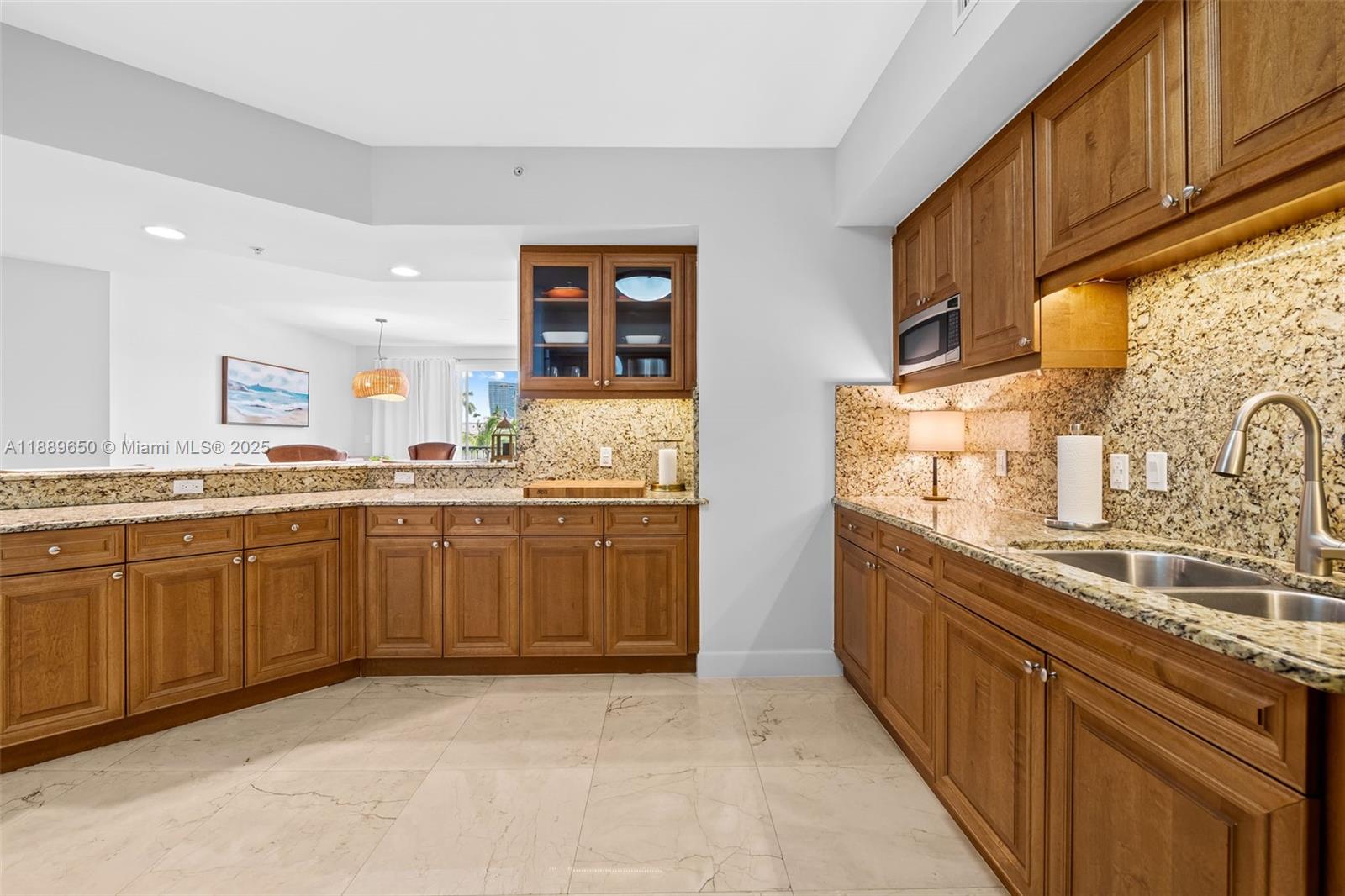 1414 Southeast 12th Street, Unit 1B Fort Lauderdale, FL 33316 - Photo 12 of 34 a kitchen with stainless steel appliances granite countertop a sink and cabinets