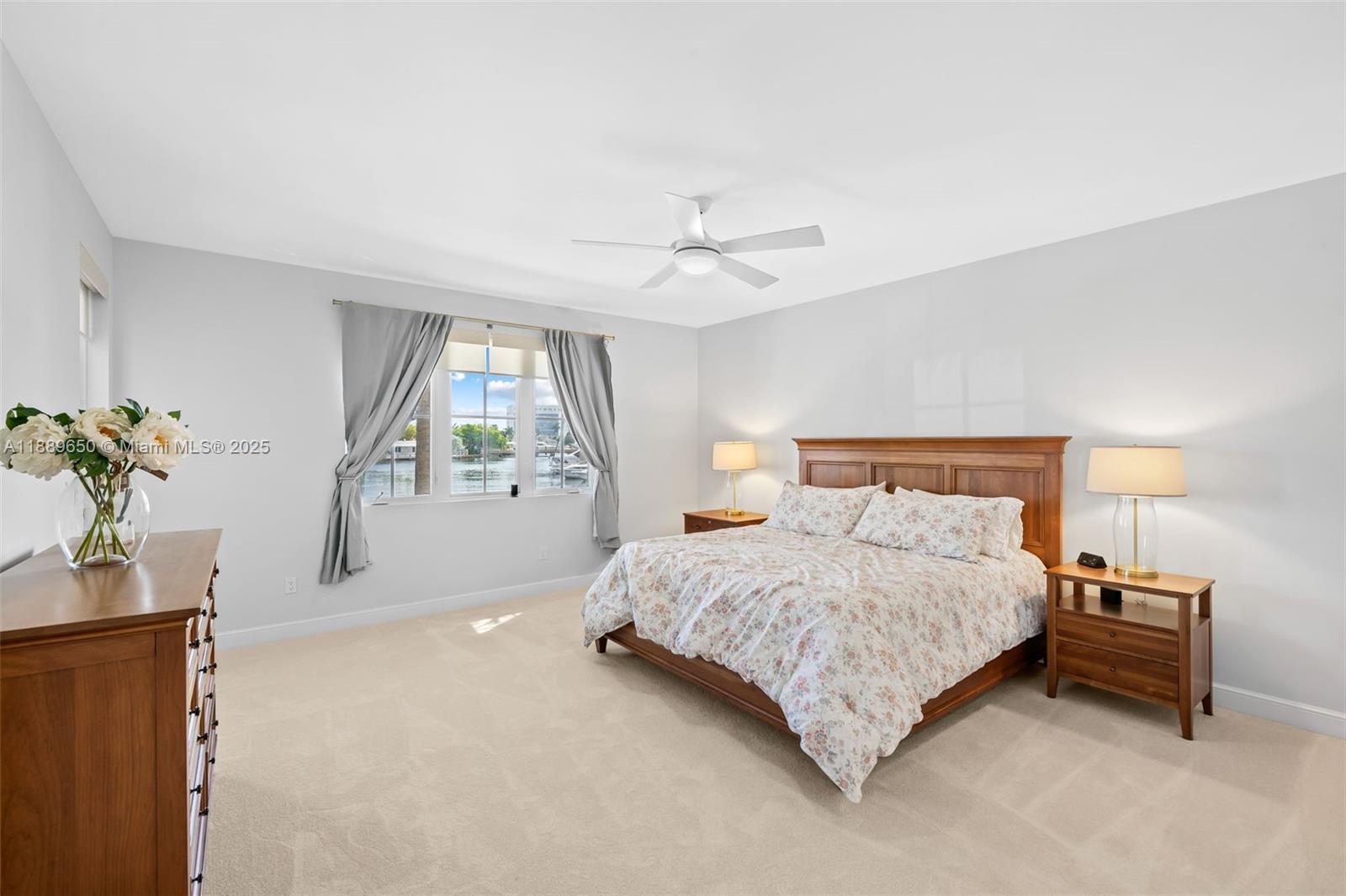 1414 Southeast 12th Street, Unit 1B Fort Lauderdale, FL 33316 - Photo 13 of 34 a bedroom with a bed and a chandelier