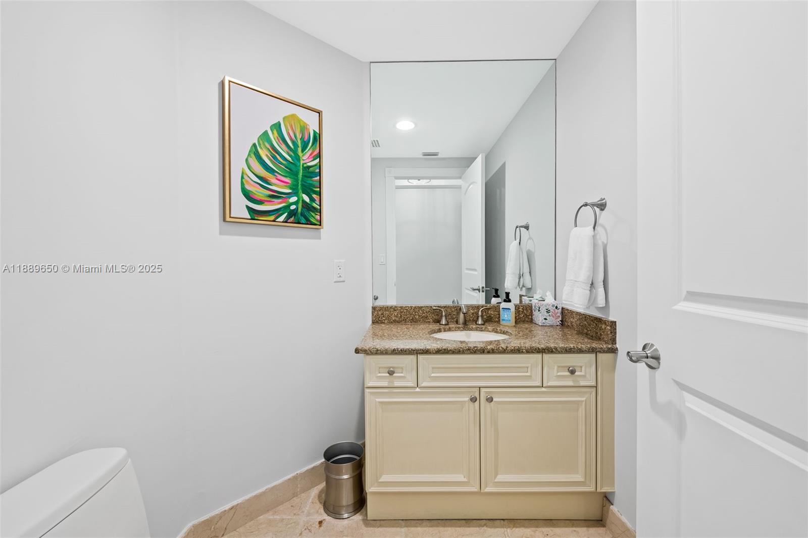1414 Southeast 12th Street, Unit 1B Fort Lauderdale, FL 33316 - Photo 23 of 34 a bathroom with a granite countertop sink and a mirror