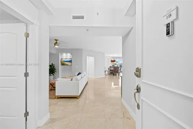 a view of a bedroom with furniture and white walls