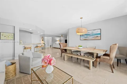 a dining room with furniture a rug and a chandelier