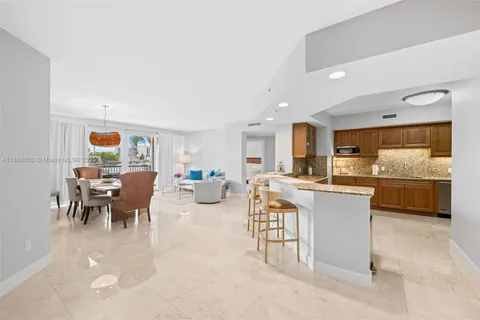 a living room with stainless steel appliances kitchen island granite countertop furniture and a kitchen view