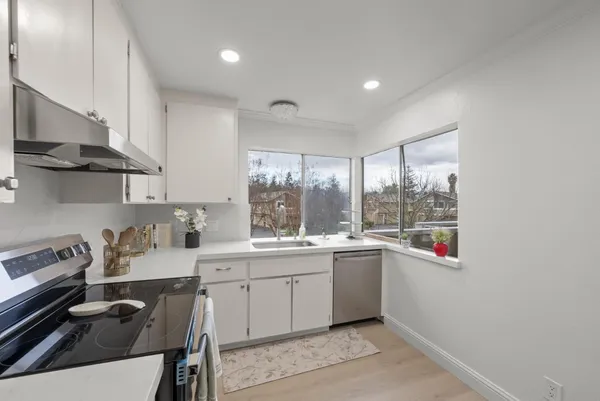 a kitchen with a sink a stove a refrigerator and blue cabinets