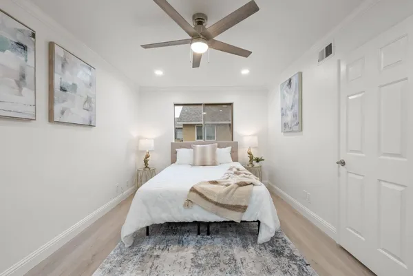 a bed sitting in a bedroom next to a window