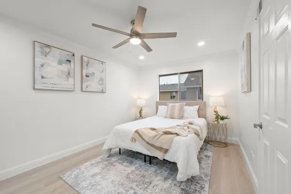 a bedroom with a bed and a painting on the wall