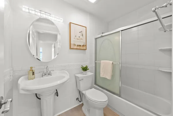 a bathroom with a sink toilet and shower