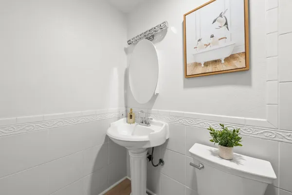 a bathroom with a sink mirror and toilet
