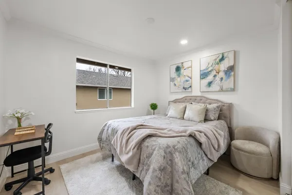 a bedroom with a bed and a chair