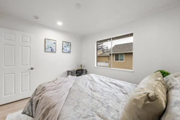 a bedroom with a bed and a window