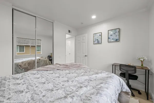 a bedroom with a bed and a dresser