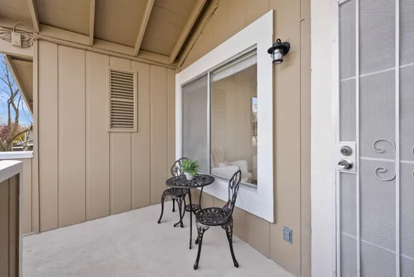 a view of a room that has a bed and a chair in it
