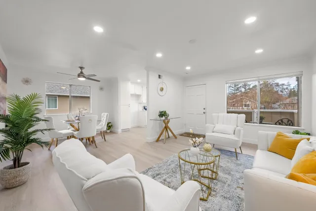 a living room with furniture and a large window