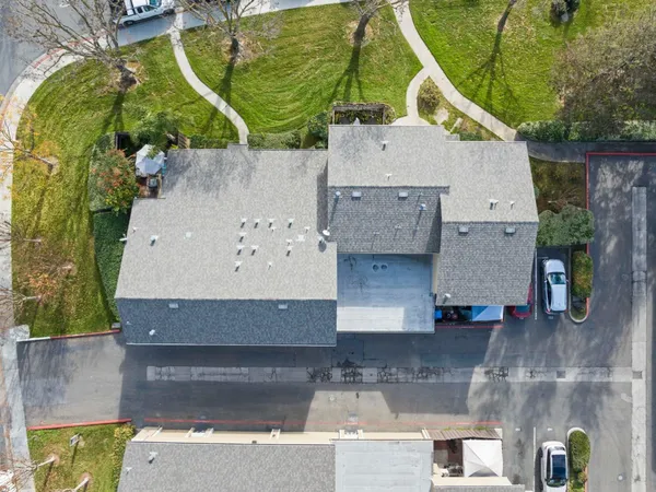 an aerial view of a house with a yard