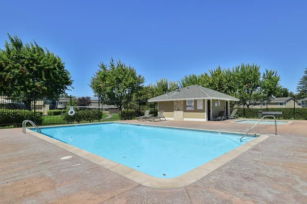 a view of a house with swimming pool and yard